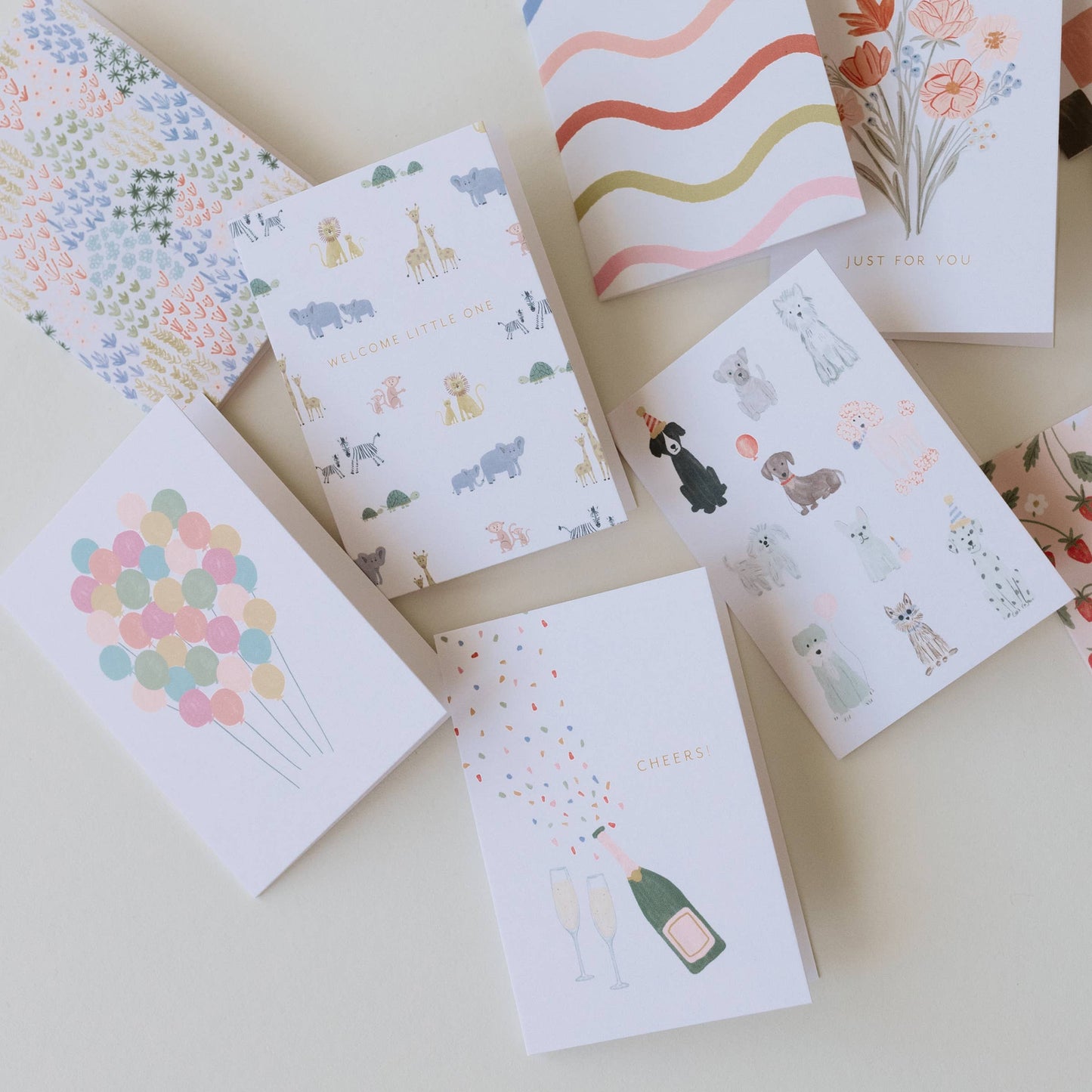Collection of small notebooks with various designs on a light surface