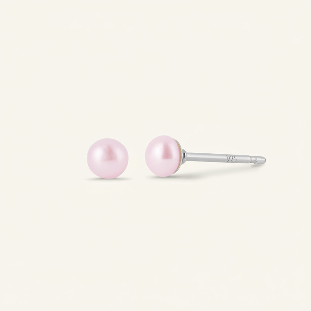 Pair of pink pearl earrings on a white background