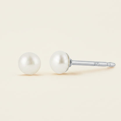 Pair of pearl stud earrings on a white background
