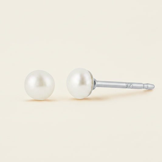 Pair of pearl stud earrings on a white background