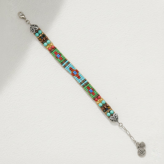 Multicolored beaded bracelet with silver clasp on a white background