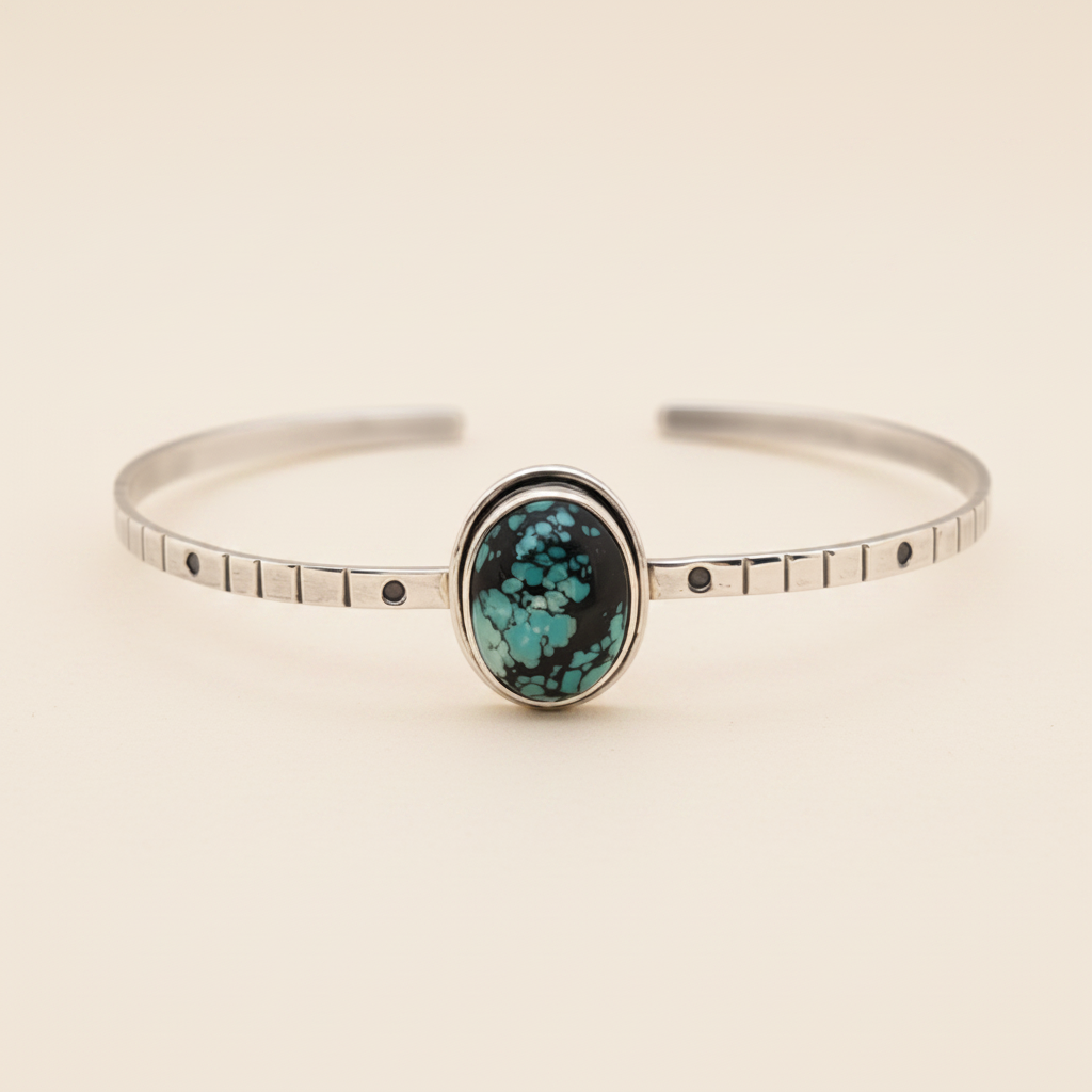 Silver bracelet with a turquoise stone on a white background
